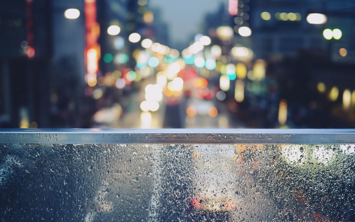 Rainy City Bokeh Through Water Droplets on Glass