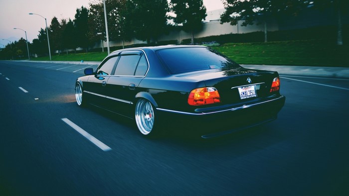 Black BMW 750iL driving on a road