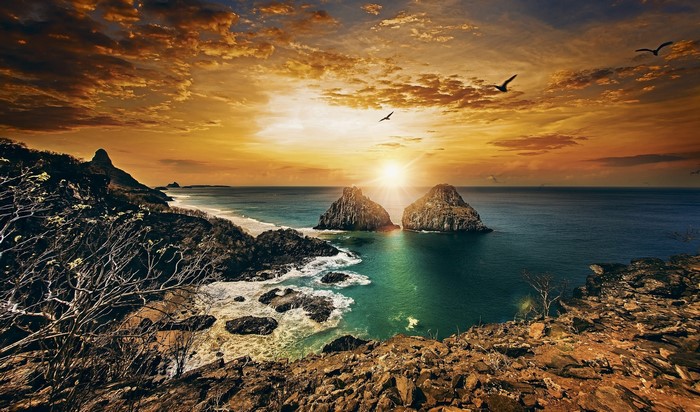 Sunset over the coast of Brazil with rock formations