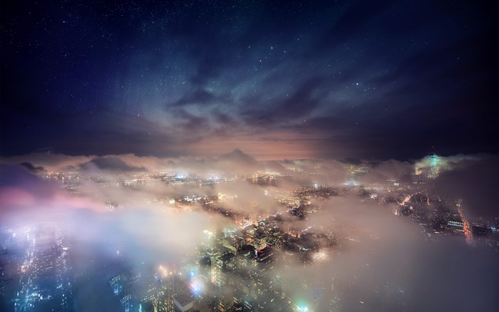 Cityscape at Night Under a Starry Sky with Clouds