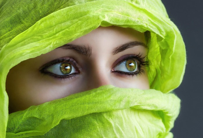 Woman with green eyes wearing a green veil