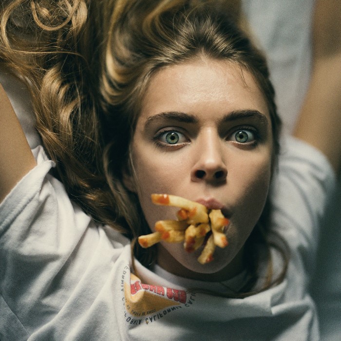 Woman with french fries in her mouth