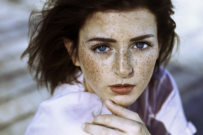 Portrait of a woman with freckles and blue eyes