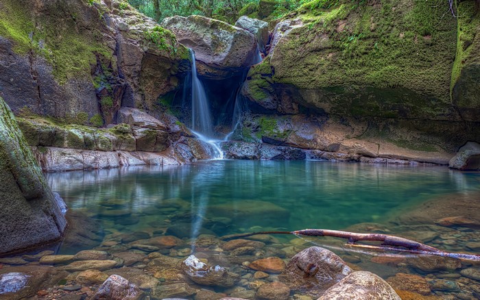 Serene Waterfall and Mossy Rock Pond