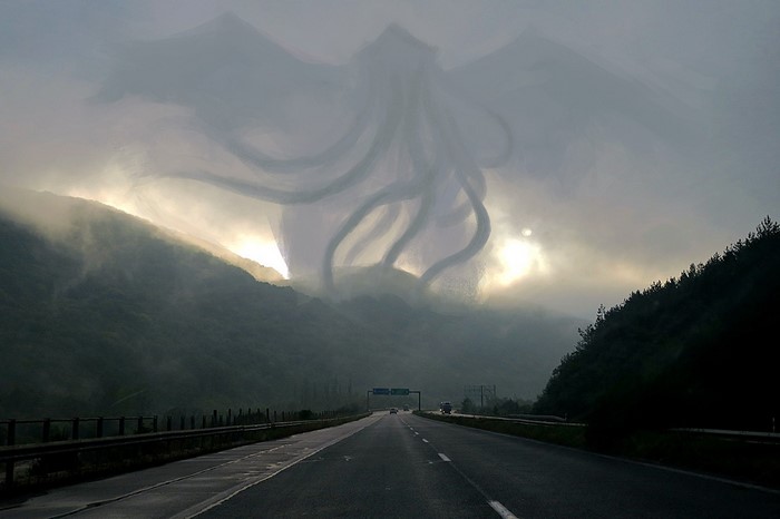 Giant cloud monster over a mountain highway