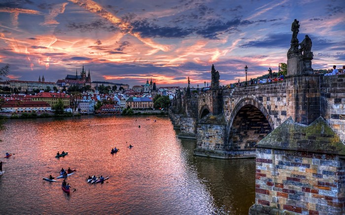 Charles Bridge and Vltava River at sunset in Prague