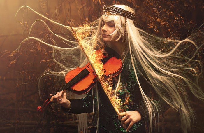 Fantasy woman playing a burning violin