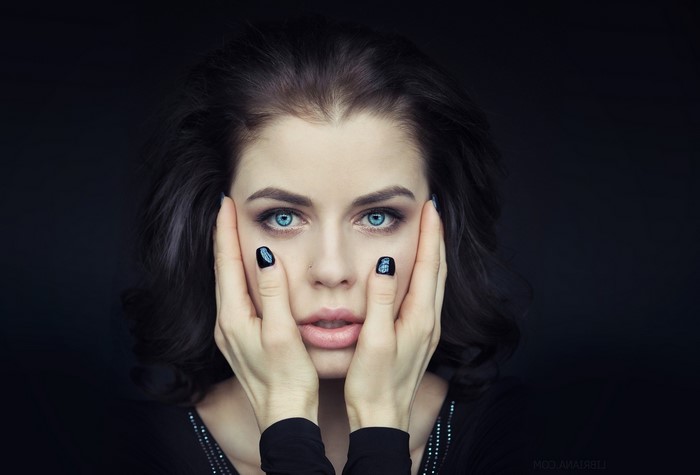 Woman with blue eyes and black nails