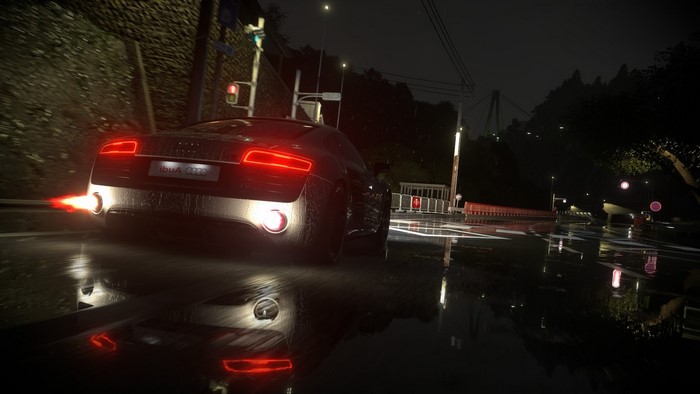 Audi R8 V10 driving on a wet road at night