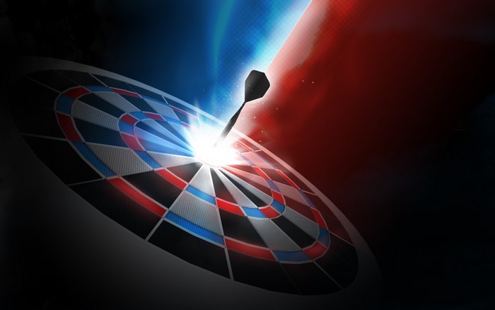 Dart hitting bullseye on glowing dartboard