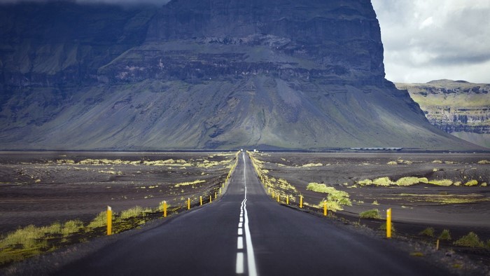 Road through Iceland landscape with mountains