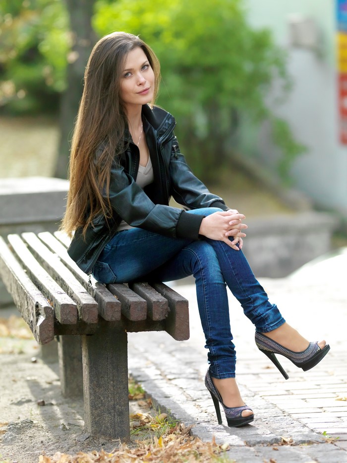 Woman with long brown hair wearing jeans and jacket