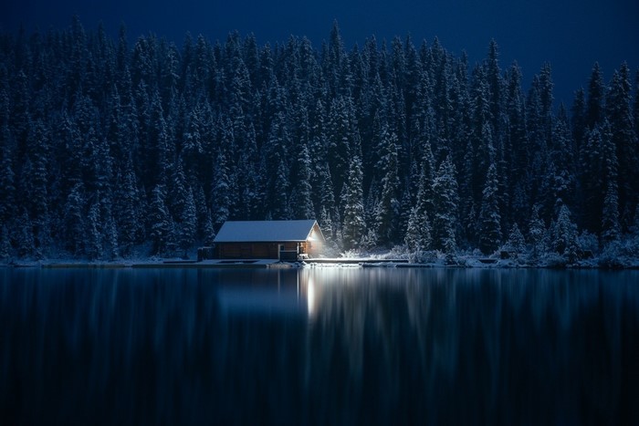 Serene Winter Cabin by Snowy Pine Forest Lake