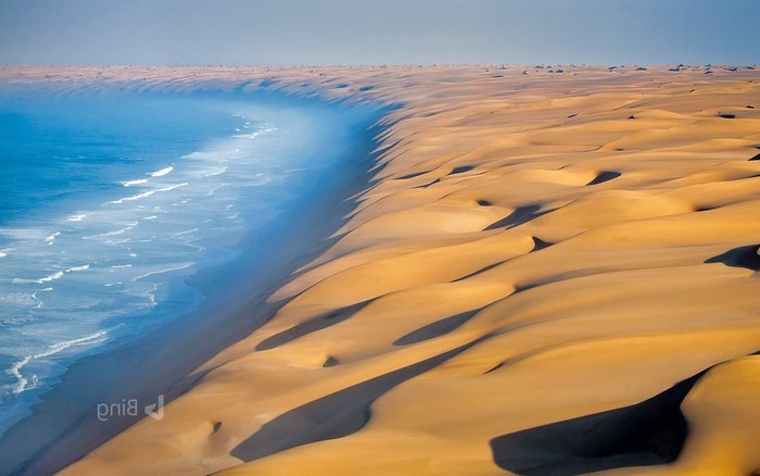 Namib Desert dunes meet the Atlantic Ocean