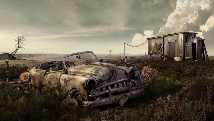 Abandoned car and shed in a wasteland