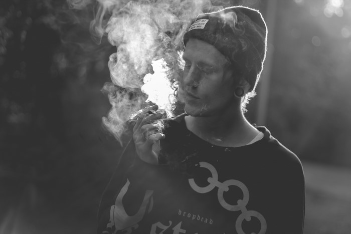 Man smoking a joint in monochrome