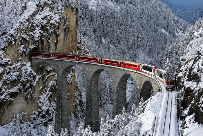 Swiss Train Crossing Snowy Mountain Bridge