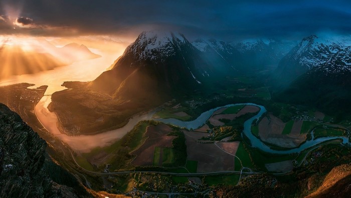 Sunset over Norwegian fjord with mountains and river