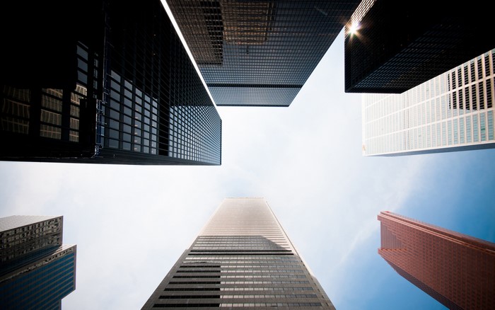 Skyscrapers viewed from below against a bright sky