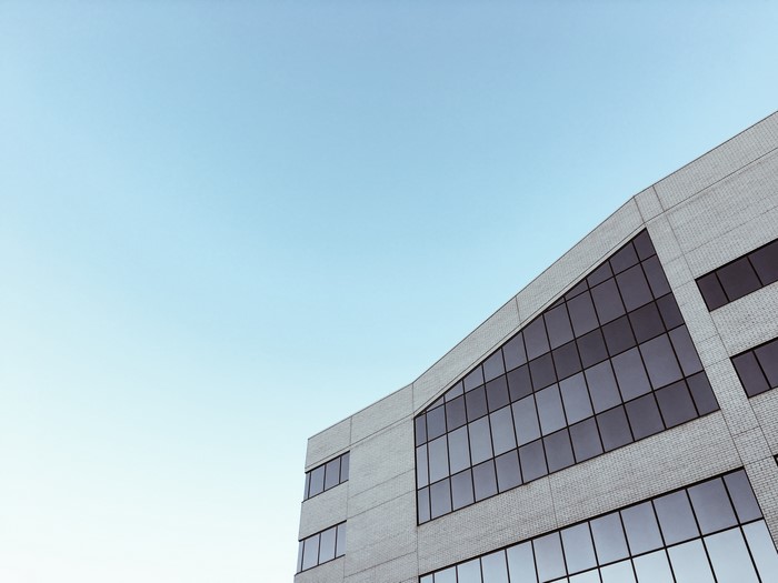 Modern building with large windows against a clear sky