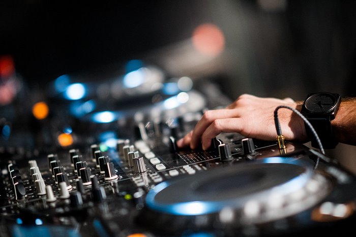 DJ mixing console with hand and watch