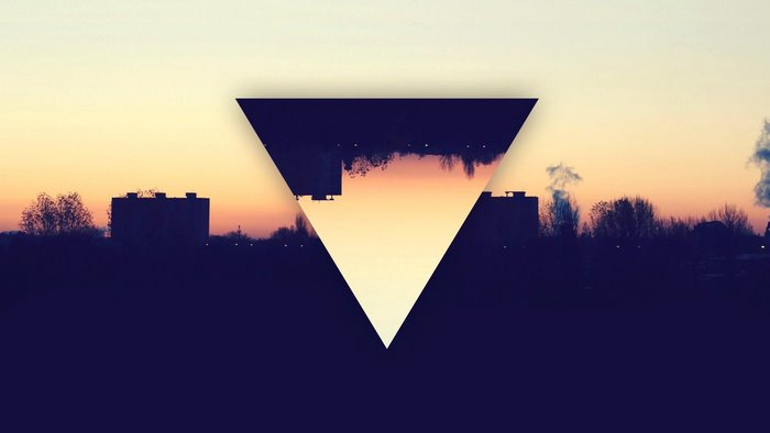 Geometric triangle overlay on city skyline at sunset