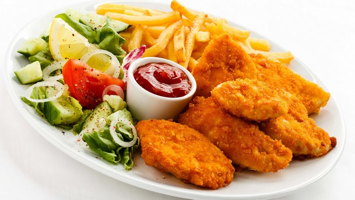 Fried chicken, french fries, and salad with ketchup