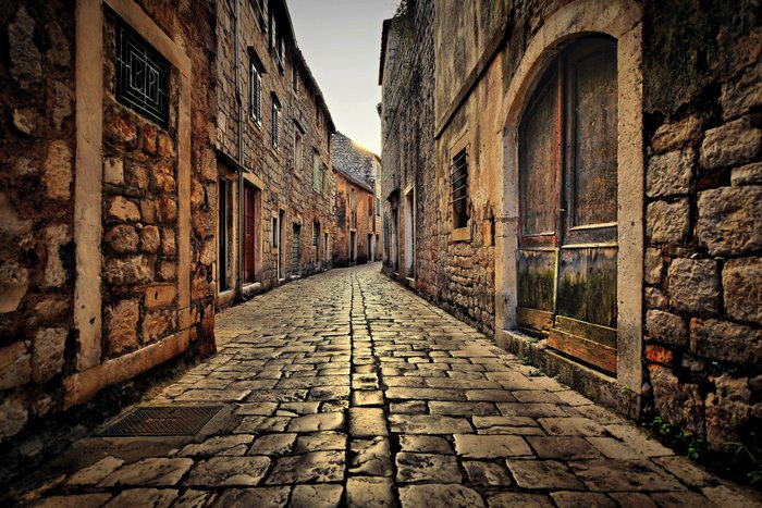 Cobblestone street in a Croatian town with stone buildings
