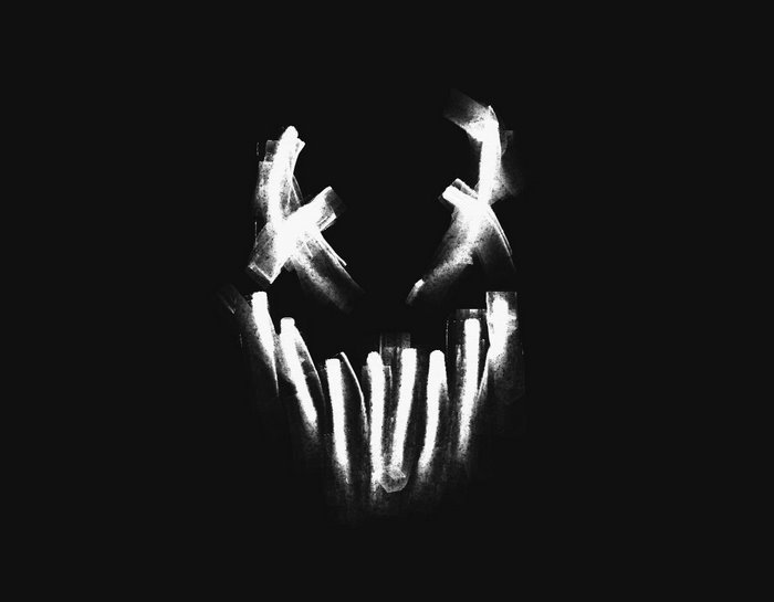 White mask with X eyes and jagged teeth on black background
