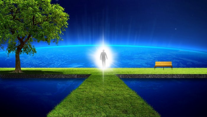 Man walking towards light over Earth