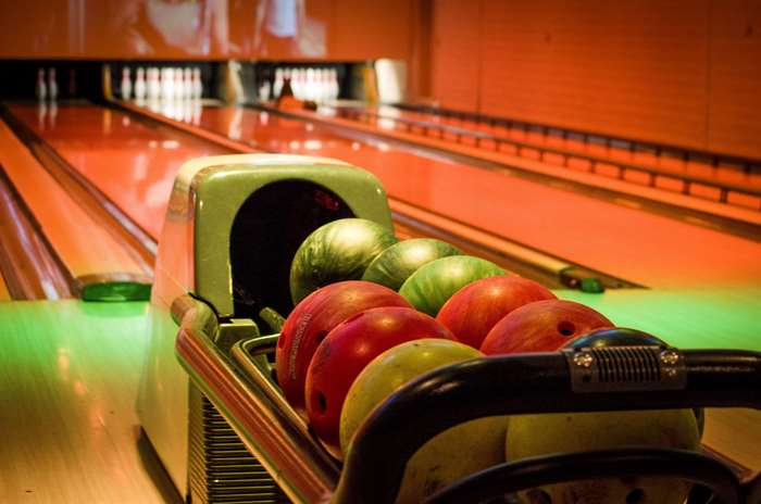 Bowling balls in a rack at a bowling alley