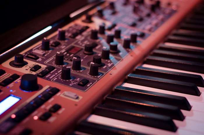 Close-up of a synthesizer keyboard with knobs and buttons