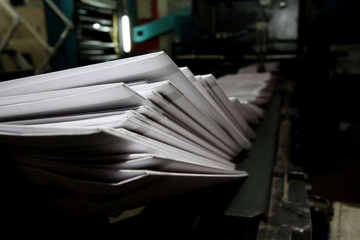 Stack of white paper on a printing press