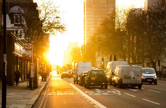 City street with traffic at sunrise or sunset