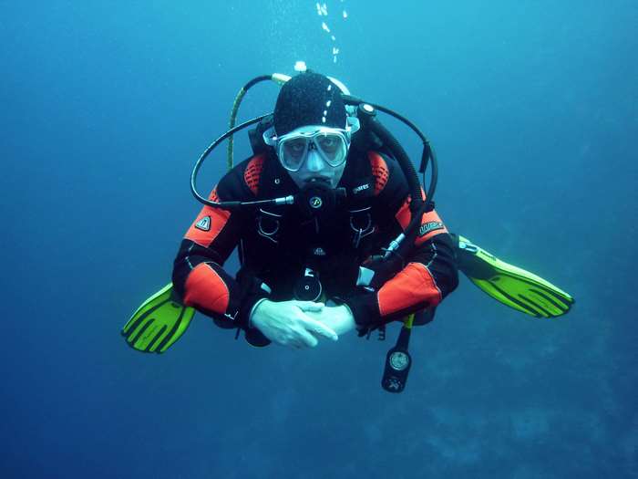 Scuba diver in a black and orange suit underwater