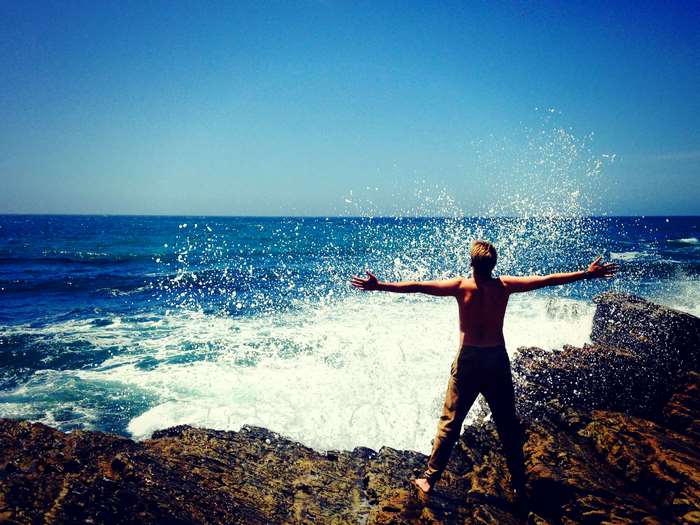 Man with arms outstretched in ocean waves