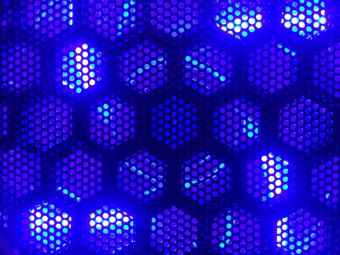 Blue lights behind a hexagonal grid
