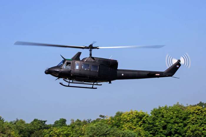 Black military helicopter in flight