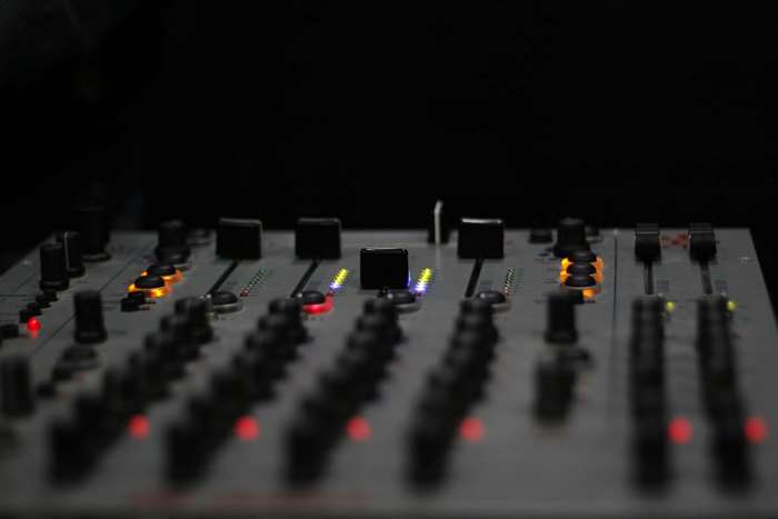 DJ mixer with illuminated faders and knobs