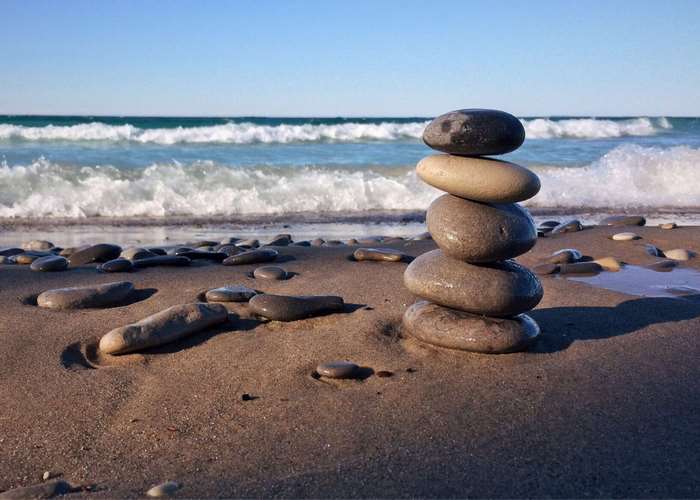 Stacked rocks on a beach with waves