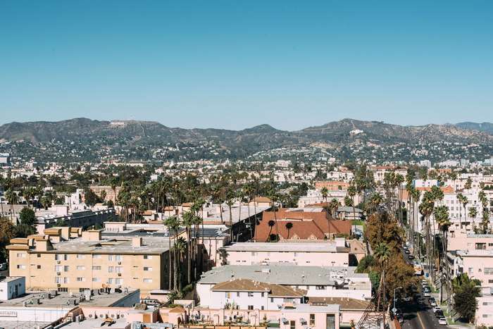 Hollywood Hills and Los Angeles cityscape with palm trees