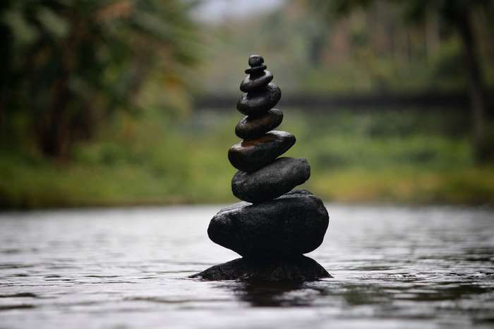 Stacked stones in water with blurred background