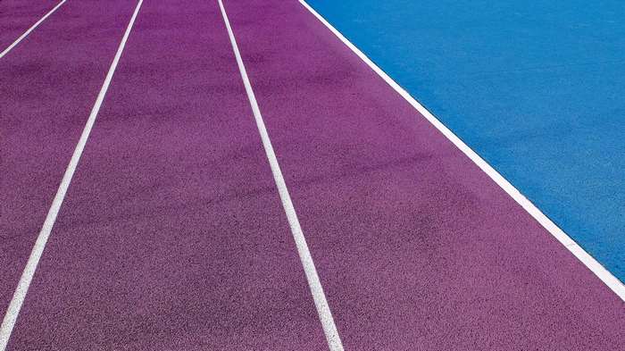 Purple and blue running track with white lines