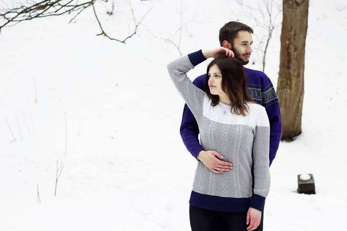 Couple in sweaters in the snow