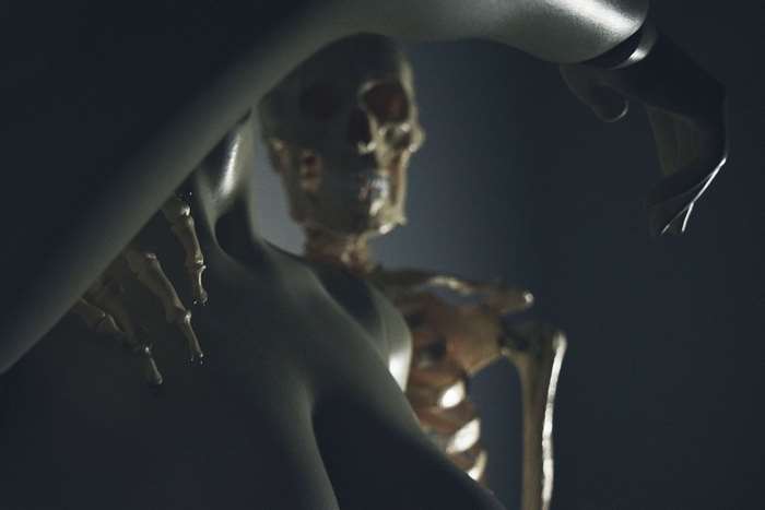 Skeleton model with robotic arm in dark lighting