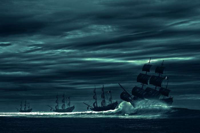 Pirate ships sailing through stormy seas