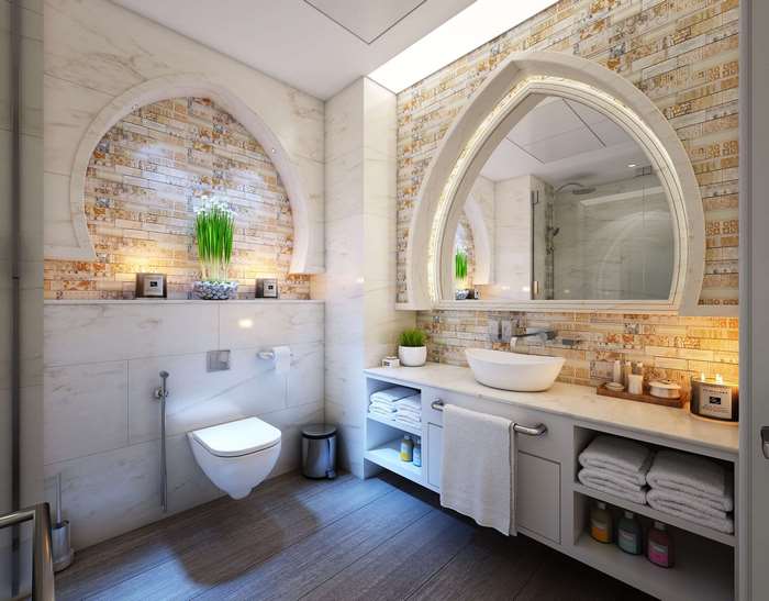 Modern luxury bathroom with arched mirror and tiled walls
