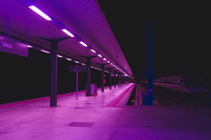 Train station platform at night with purple lights