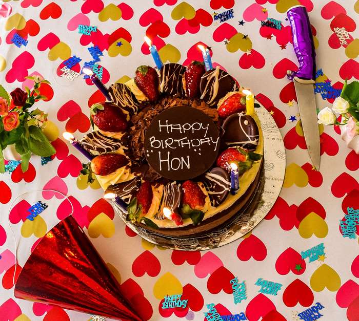 Chocolate birthday cake with strawberries and candles
