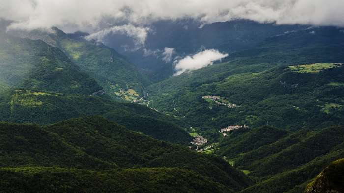 4K cloudy mountains and village in Italy